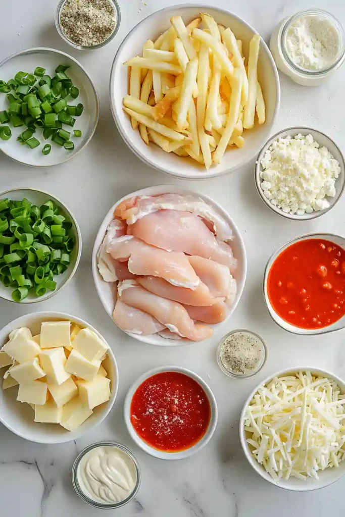 A tray of Buffalo Chicken Fries topped with crispy golden fries, spicy buffalo chicken, melted pepper jack and Monterey Jack cheese, ranch dressing, and green onions. This loaded game day appetizer looks cheesy, bold, and freshly baked.