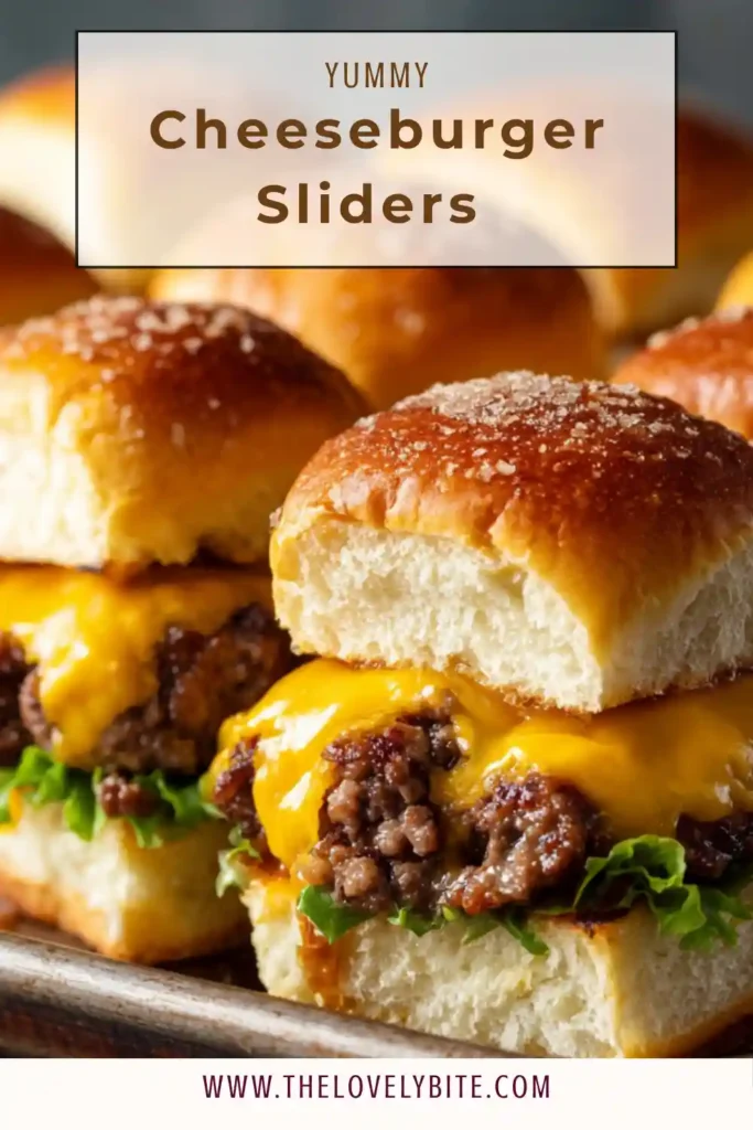 Freshly baked cheeseburger sliders with melted cheese and sesame seed buns arranged in a baking tray. The sliders look golden and juicy.