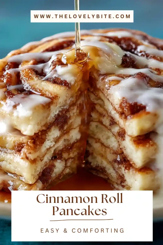 Fresh homemade cinnamon roll pancakes drizzled with creamy glaze and served warm. The fluffy pancakes feature a rich cinnamon sugar swirl.