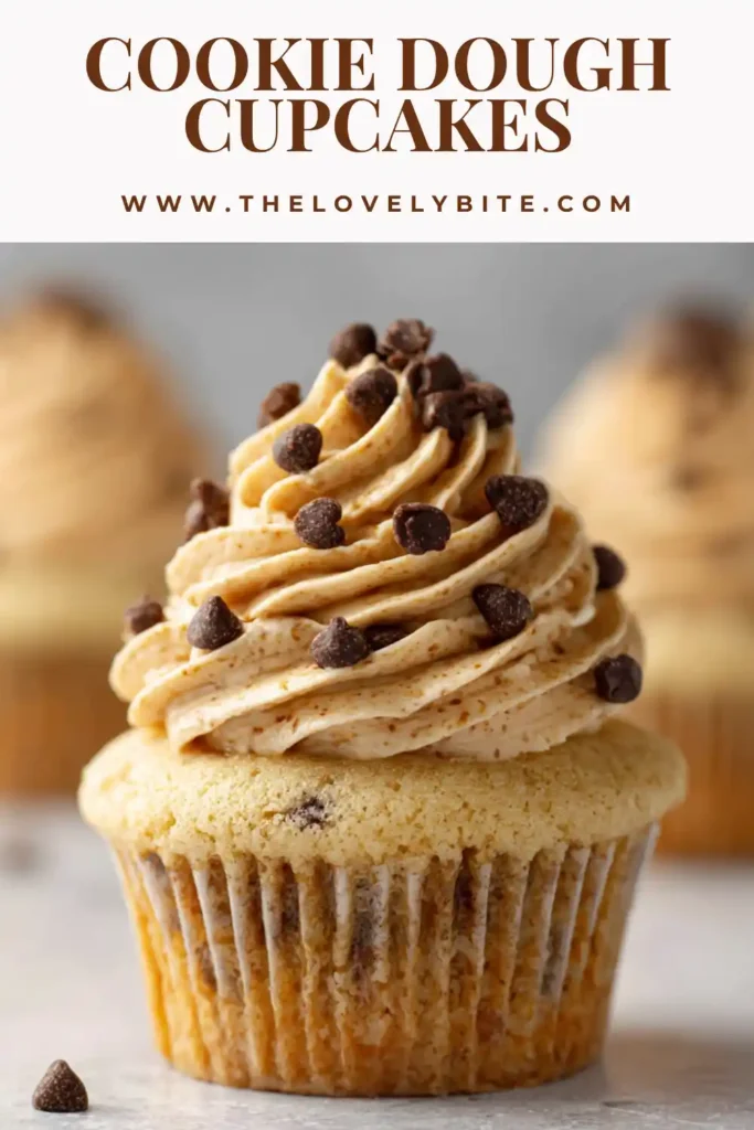A batch of homemade Cookie Dough Cupcakes with fluffy frosting and chocolate chip garnish. These dessert cupcakes feature a rich edible cookie dough center and golden vanilla cupcake base.