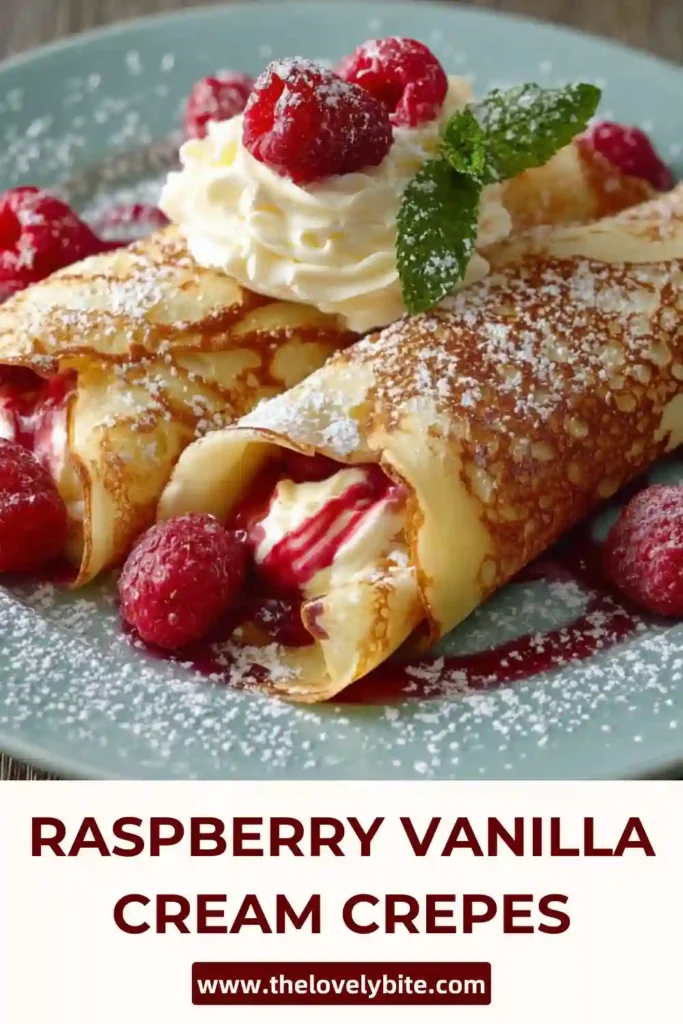 Delicate Raspberry Vanilla Cream Crepes arranged on a serving plate with fresh berries and vanilla cream peeking through each fold. A drizzle of raspberry sauce makes this sweet crepes recipe look rich and inviting.