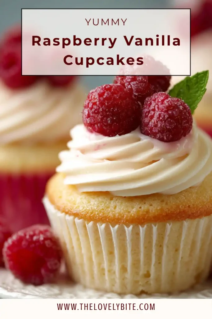 Freshly baked Raspberry Vanilla Cupcakes arranged on a tray with creamy pink frosting and mint garnish. This fruity cupcake recipe is ideal for birthdays, brunches, and party dessert tables.