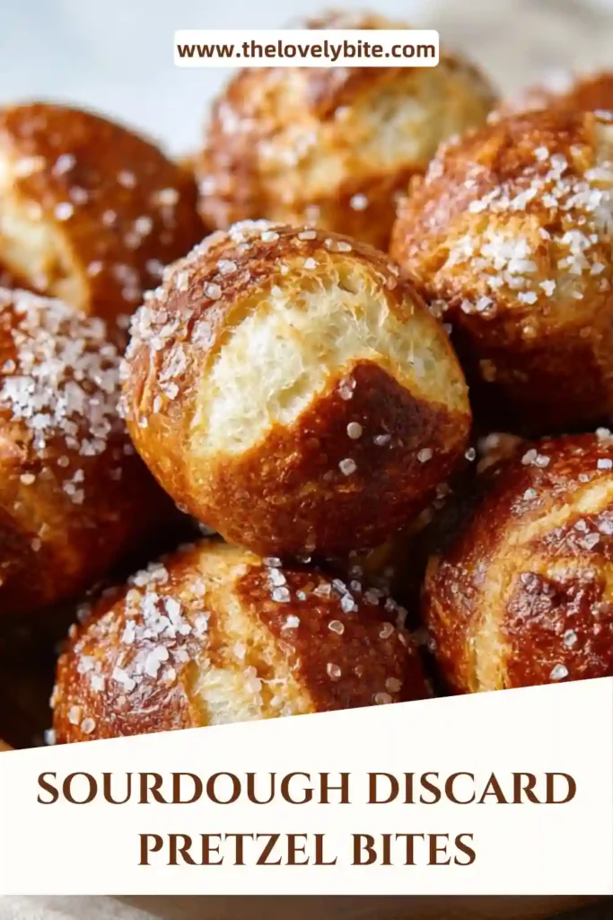 Homemade Sourdough Discard Pretzel Bites arranged on a parchment-lined baking sheet. This easy sourdough discard recipe creates bite-sized pretzels with a classic chewy texture.