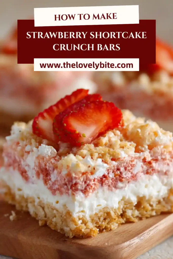 Close-up of Strawberry Shortcake Crunch Bars showing the creamy frosting and crumbly strawberry shortcake topping. These dessert bars have a soft texture with a crisp, buttery finish.