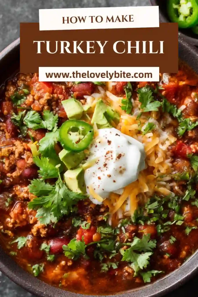 A close-up of turkey chili with sweet potatoes, diced tomatoes, and ground turkey in a deeply flavorful broth. This easy chili recipe looks comforting, wholesome, and ideal for meal prep.