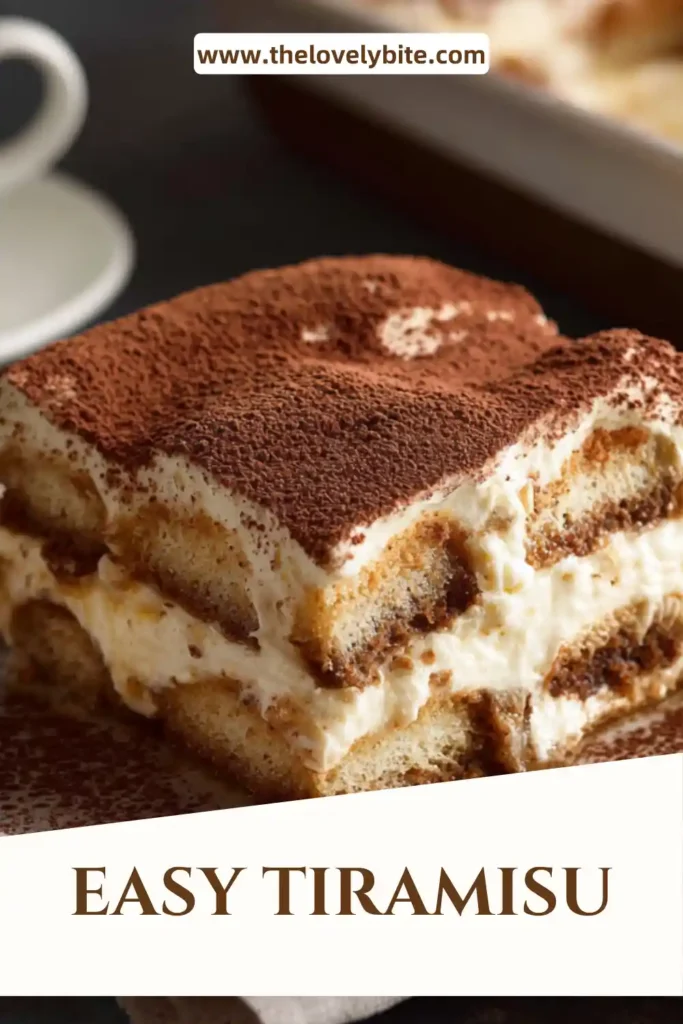 Easy tiramisu served in a square dish with visible creamy layers and a generous dusting of cocoa. The coffee dessert has a smooth texture and classic homemade appeal.