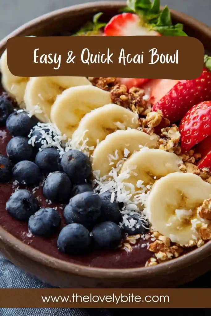 A vibrant acai bowl recipe topped with fresh strawberries, banana slices, blueberries, and granola in a white bowl. The smoothie base looks thick and creamy.