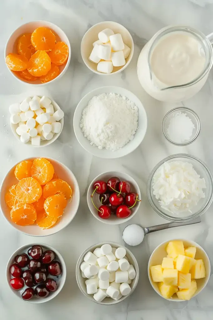 A bowl of Ambrosia Salad Recipe filled with mandarin oranges, pineapple, cherries, and marshmallows in creamy dressing. The texture looks light, fluffy, and rich.