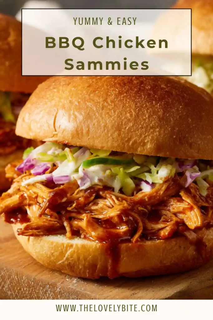 Close-up of BBQ Chicken Sammies showing tender shredded chicken coated in thick sauce inside a soft sandwich roll. The texture looks moist and delicious.