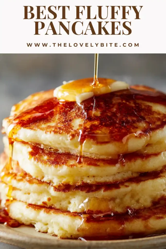 Close-up of fluffy pancakes showing a soft and tender interior. The pancakes are golden and stacked neatly.