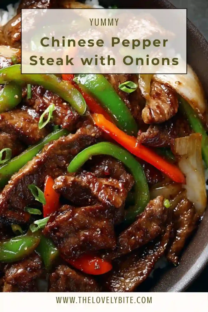 A skillet filled with Chinese Pepper Steak with Onions showing seared beef and soft onions coated in sauce.