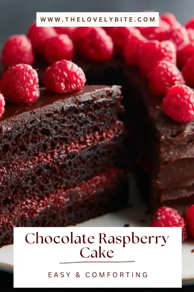 Homemade Chocolate Raspberry Cake decorated with fresh raspberries and creamy chocolate frosting. Perfect dessert presentation on a cake stand.