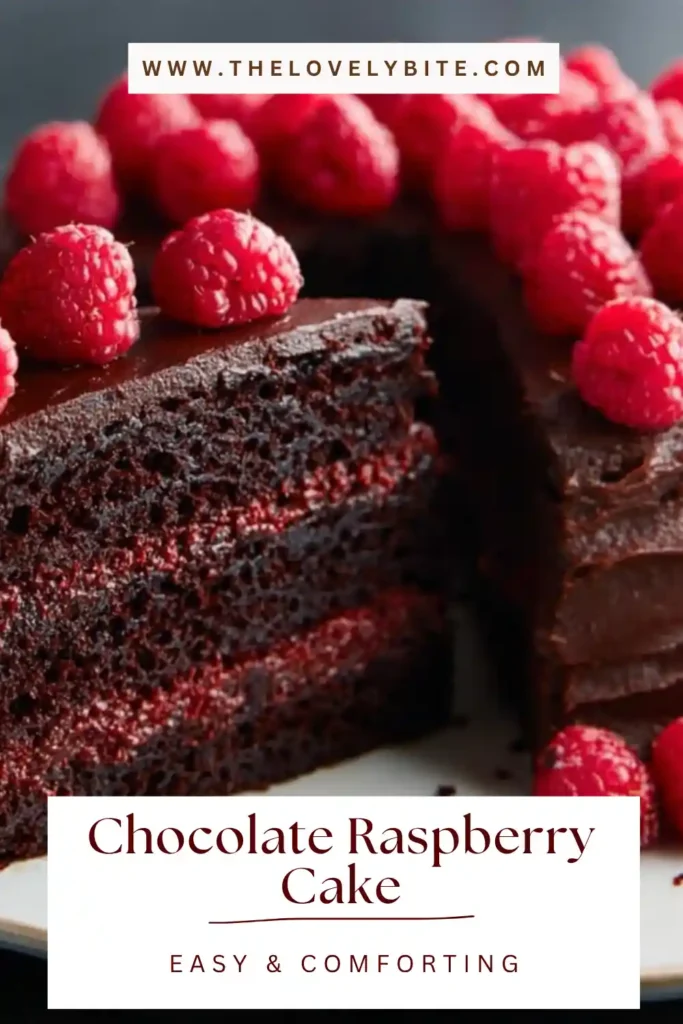 A layered Chocolate Raspberry Cake with rich chocolate frosting and fresh raspberries on top. The cake shows moist texture and vibrant raspberry filling between layers.
