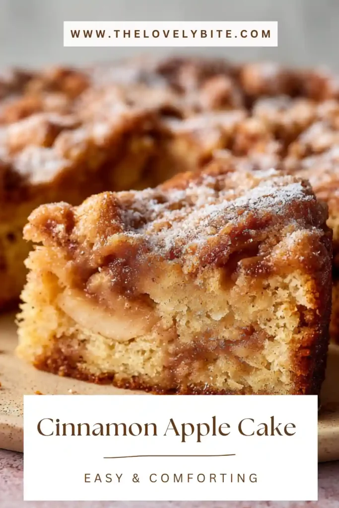 Homemade Cinnamon Apple Cake in a baking tray topped with smooth icing glaze and warm cinnamon tones. The cake appears fluffy and perfectly baked.