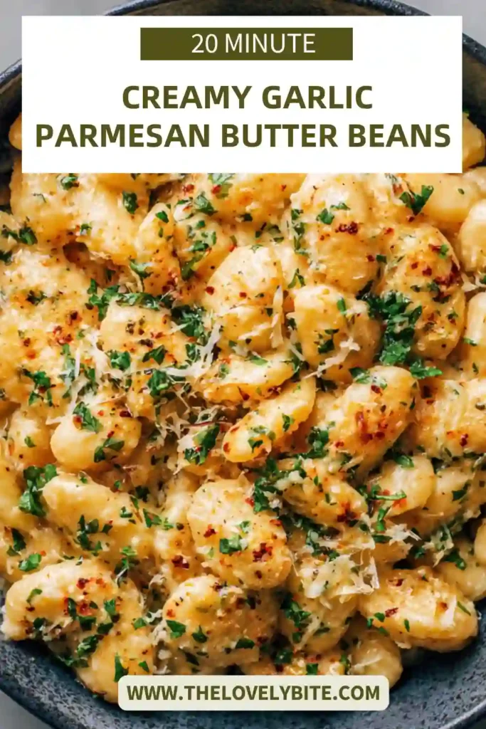 A warm serving of creamy butter beans garnished with herbs, showcasing a comforting and hearty vegetarian dish.
