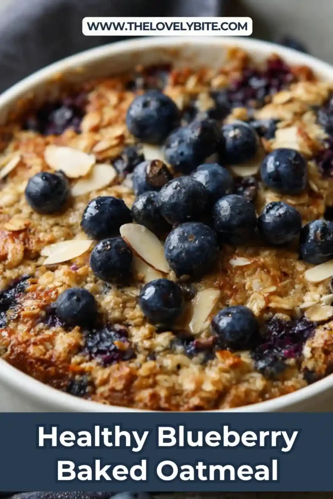 A golden baked healthy blueberry baked oatmeal topped with fresh blueberries and sliced almonds in a square baking dish. The texture looks soft and moist, perfect for breakfast.