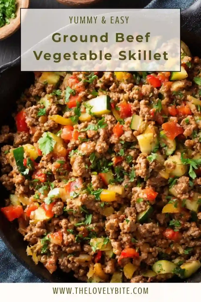 Overhead view of healthy ground beef vegetable skillet in a cast iron pan with vibrant vegetables.