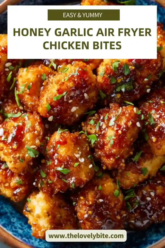 Freshly cooked Honey Garlic Air Fryer Chicken Bites arranged on a plate with dipping sauce and garnish. The chicken appears golden and juicy.