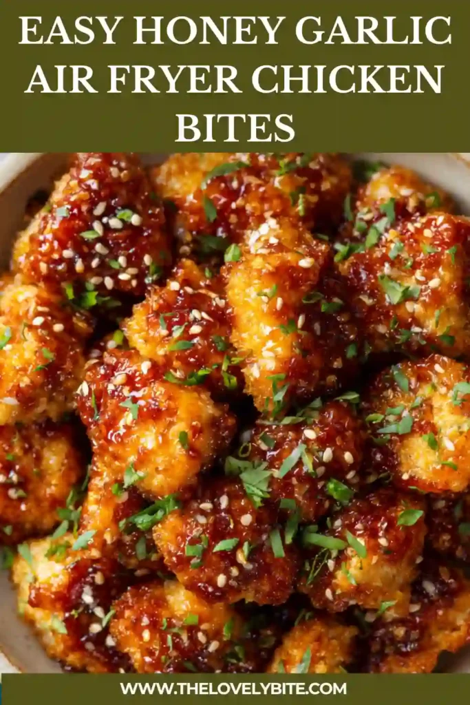 Bowl of Honey Garlic Air Fryer Chicken Bites with thick sauce coating and sprinkled sesame seeds, highlighting crispy texture and rich flavor.