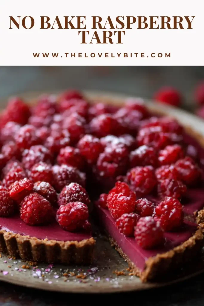 Close-up of a slice of no bake raspberry tart showing layers of chia jam and smooth cashew cream filling.