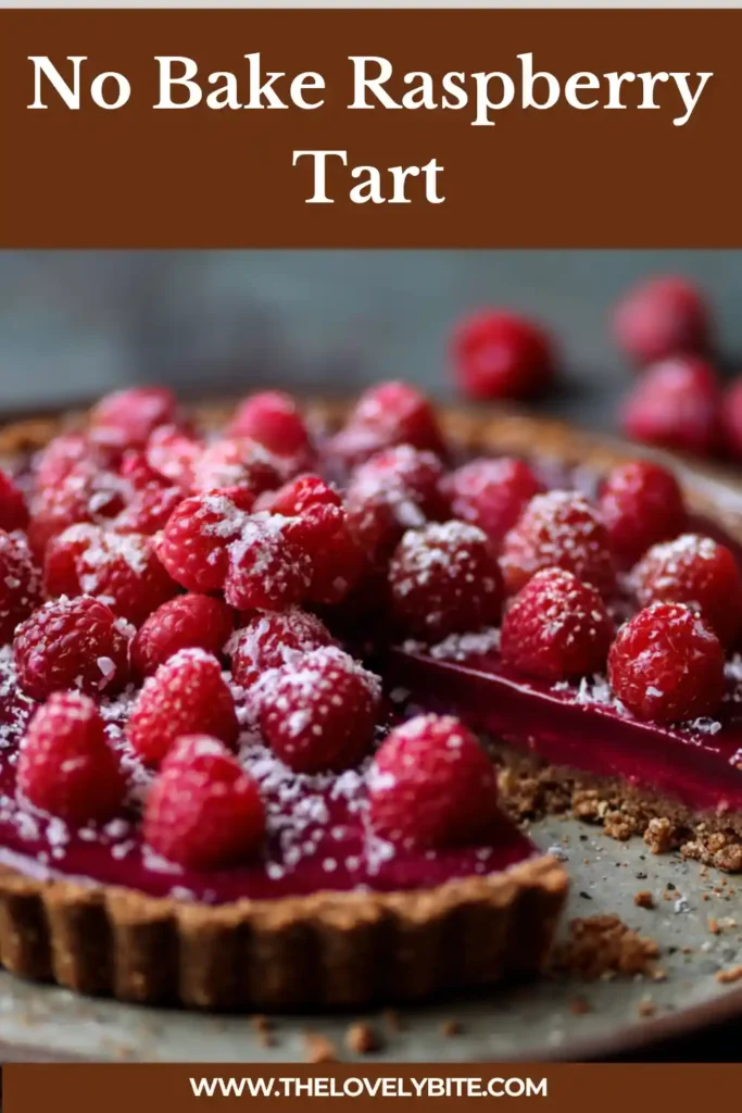 A no bake raspberry tart with a creamy pink filling and chocolate hazelnut crust, topped with fresh berries and edible flowers.