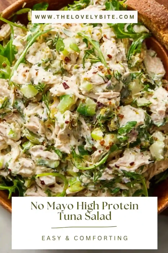 Freshly prepared no mayo high protein tuna salad in a bowl with bright green avocado and chopped vegetables.