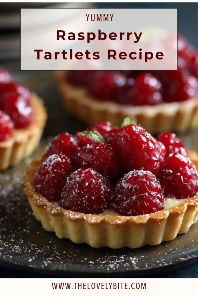 Freshly baked raspberry tartlets with crisp pastry crust and rich custard filling, garnished with ripe raspberries.