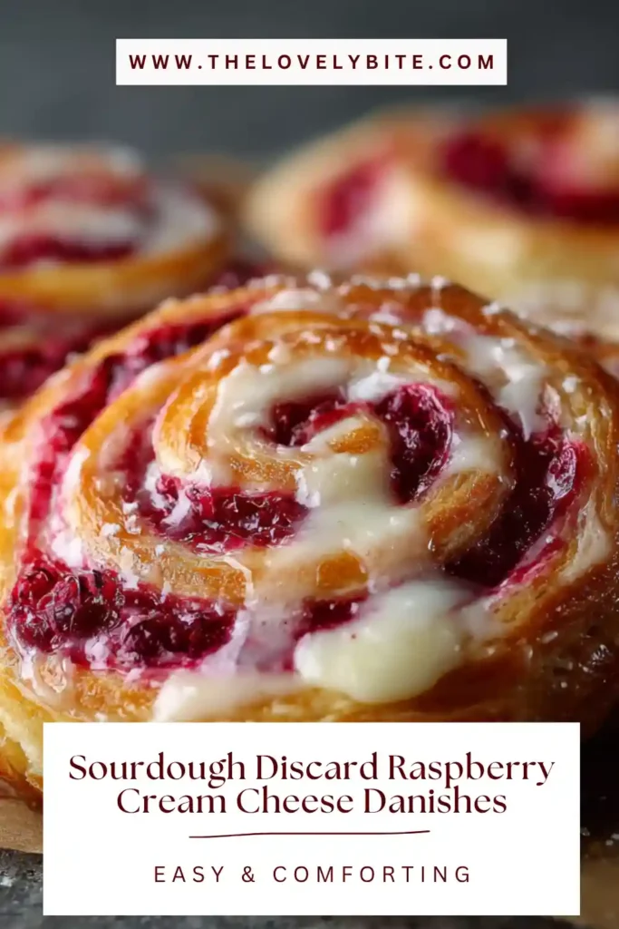Close-up of sourdough discard raspberry cream cheese danishes showing rich cream cheese filling and thick raspberry sauce. The texture appears tender and bakery-style.