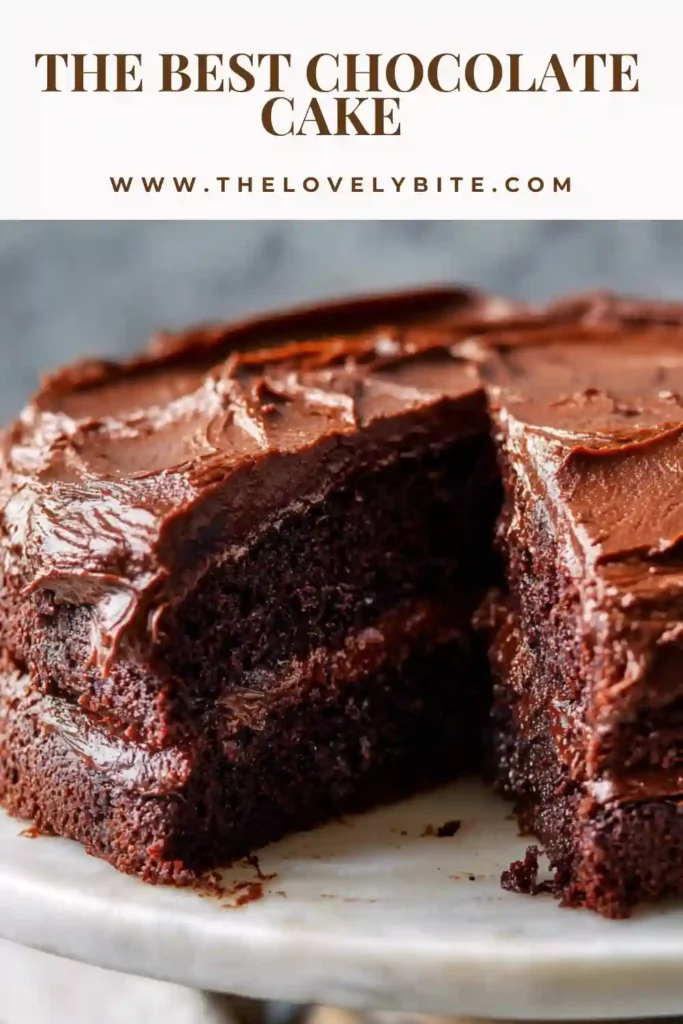 Close-up of a slice from the best chocolate cake recipe showing fluffy layers and creamy chocolate buttercream frosting.
