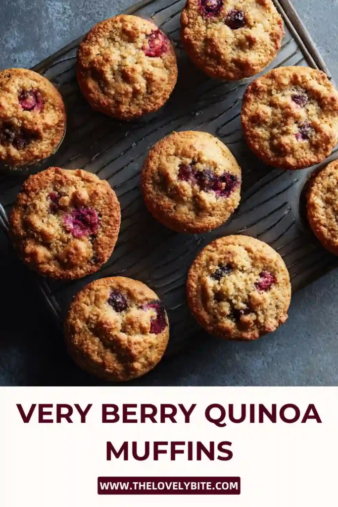 Freshly baked Very Berry Quinoa Muffins filled with raspberries and made with almond flour, displayed on a cooling rack in natural light.