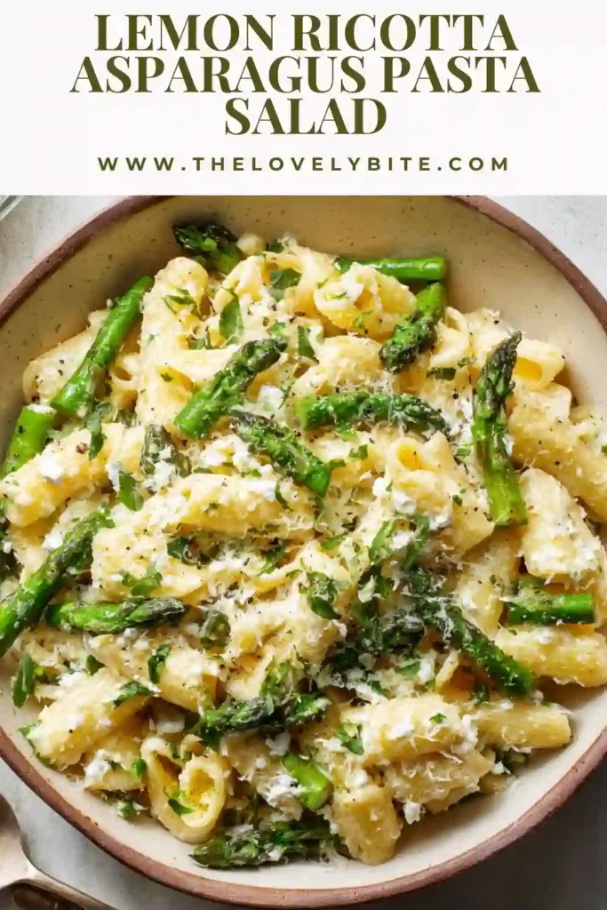 Close-up of Lemon Ricotta Asparagus Pasta Salad topped with fresh basil and lemon zest. The creamy ricotta sauce coats every piece of pasta for a rich yet refreshing dish.