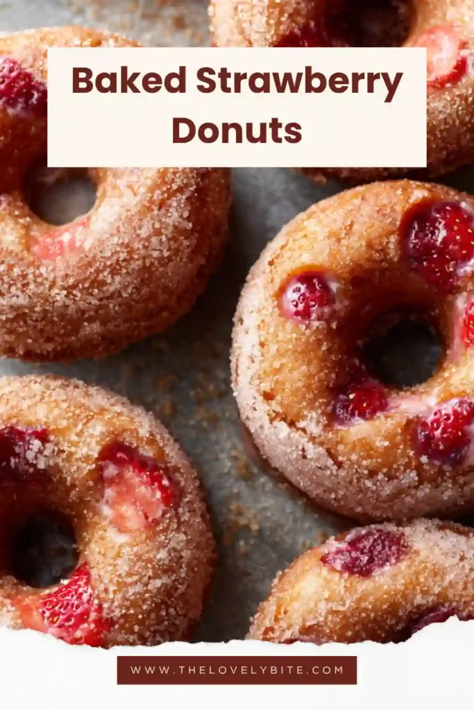 Close-up of homemade Baked Strawberry Donuts topped with cinnamon sugar coating. The donuts are soft, golden, and packed with fresh strawberry flavor.