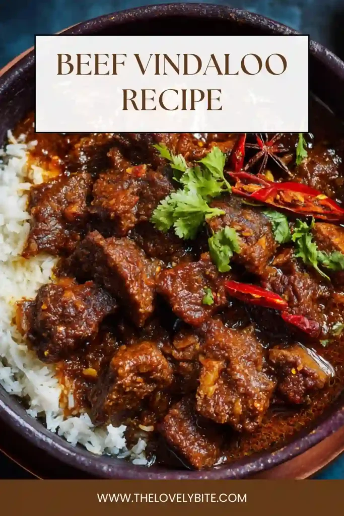 Close-up of Beef Vindaloo curry with tender beef chuck in a thick spicy tomato gravy garnished with fresh cilantro. This hearty homemade curry recipe is rich, savory, and deeply flavorful.
