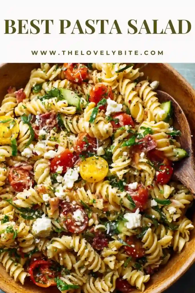A vibrant Best Pasta Salad recipe made with rotini pasta, fresh herbs, mozzarella, and beef salami mixed in a zesty homemade dressing. The salad is colorful, hearty, and refreshing.