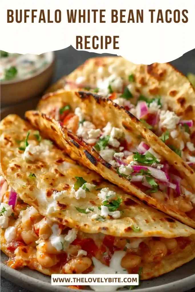 Close-up of Buffalo White Bean Tacos filled with buffalo white beans and topped with avocado slices and fresh vegetables. A colorful and flavorful meatless taco recipe perfect for weeknights.