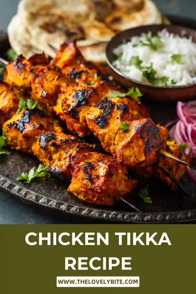 Close-up of grilled chicken tikka skewers with smoky edges and vibrant Indian spices. This easy chicken tikka recipe features tender yogurt-marinated chicken.