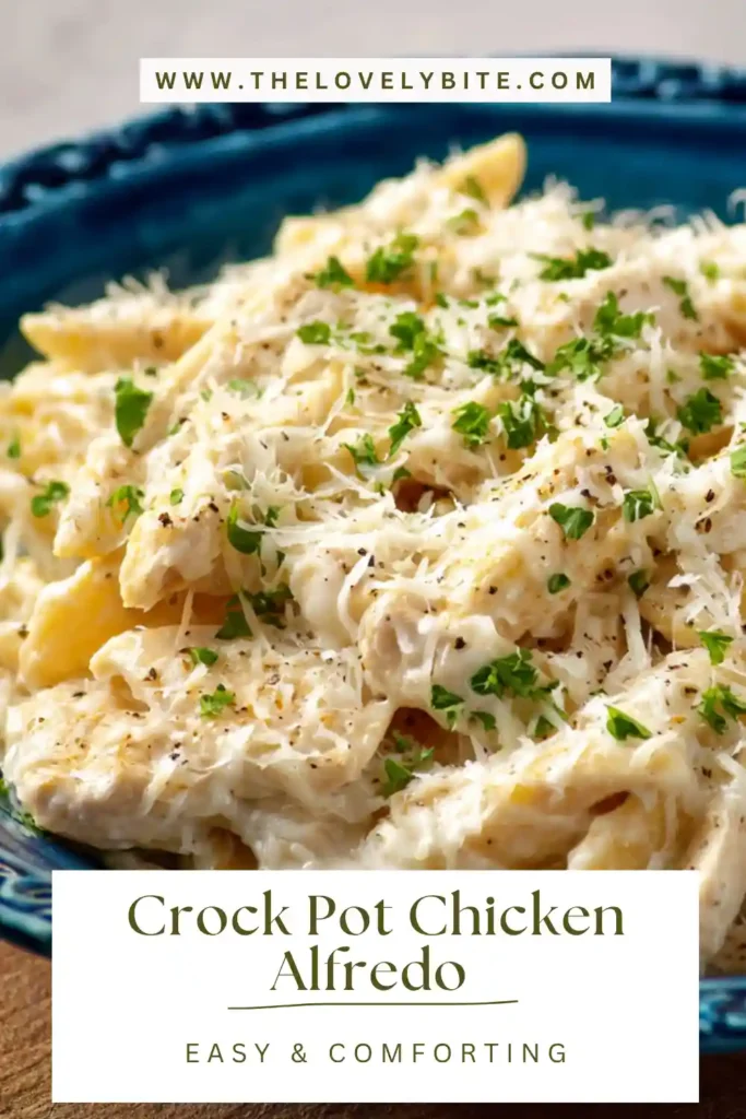 Crock Pot Chicken Alfredo Recipe served in a bowl with creamy sauce clinging to penne pasta and topped with fresh parsley.