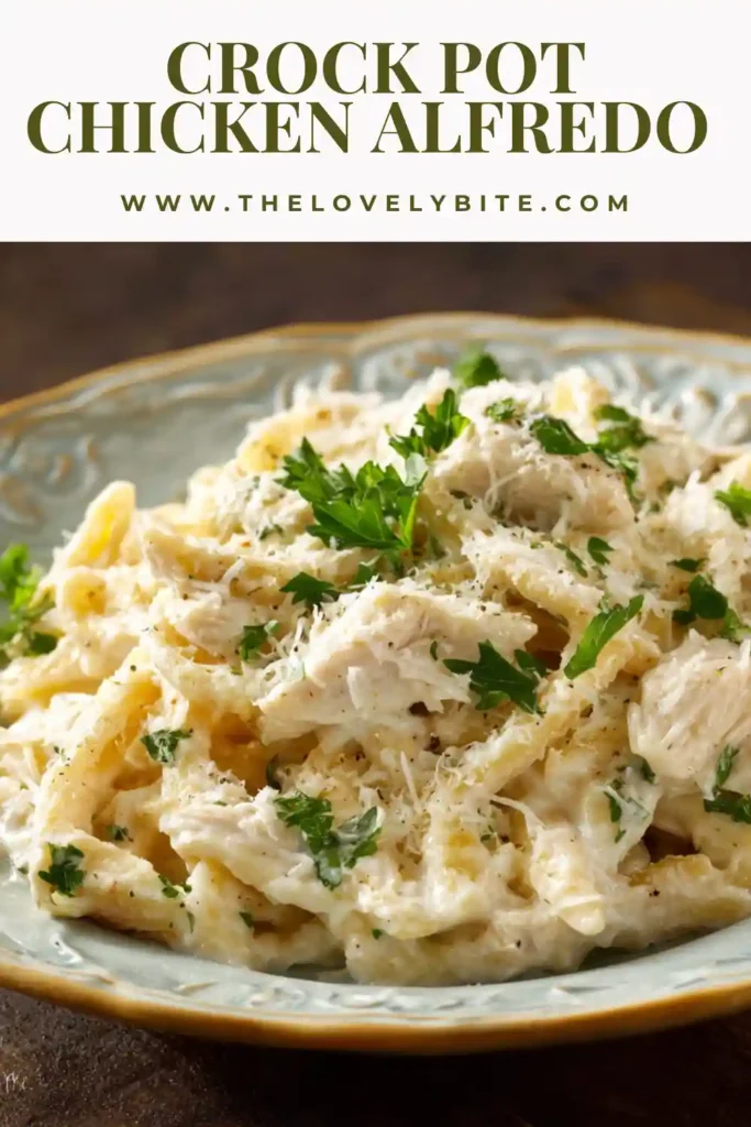 Homemade slow cooker chicken alfredo with thick creamy sauce, shredded chicken, and parmesan cheese melted over pasta.