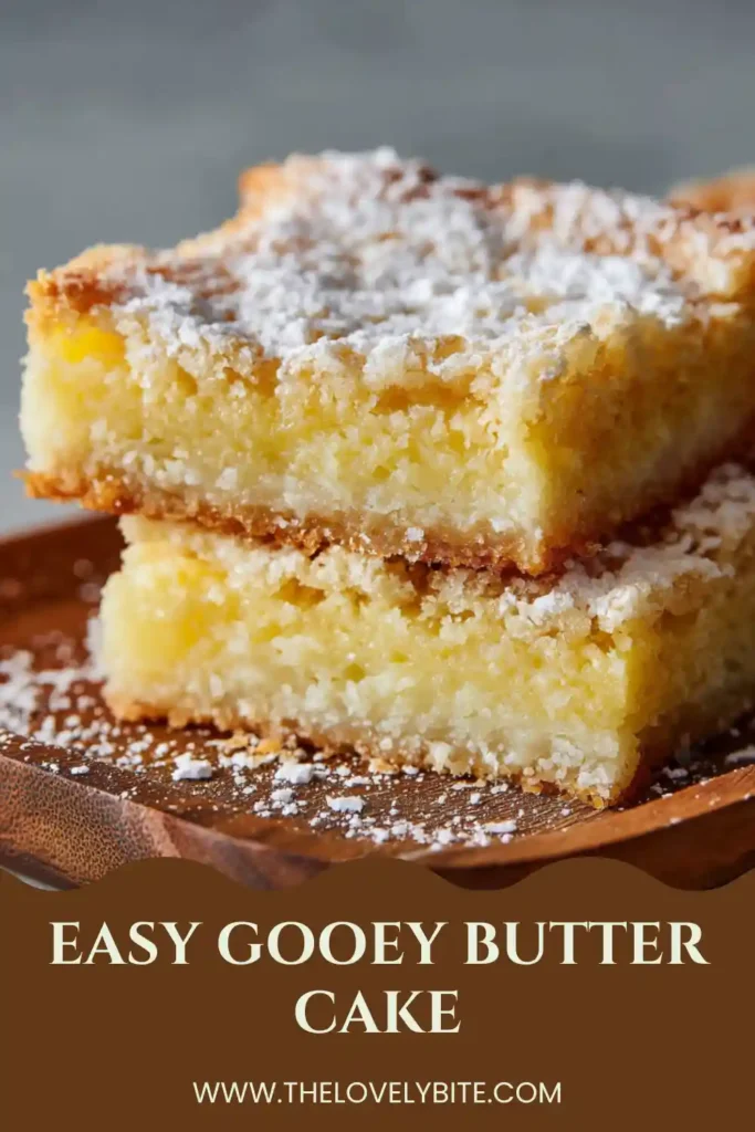 Freshly baked Easy Gooey Butter Cake served on a dessert plate with powdered sugar topping. The cake has a gooey texture and buttery flavor.