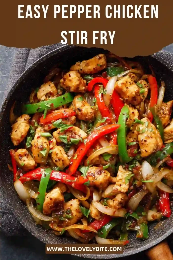 Easy Pepper Chicken Stir Fry cooked in a wok with juicy chicken breast, onions, and red and green bell peppers. The rich black pepper sauce gives the dish a delicious glossy finish.