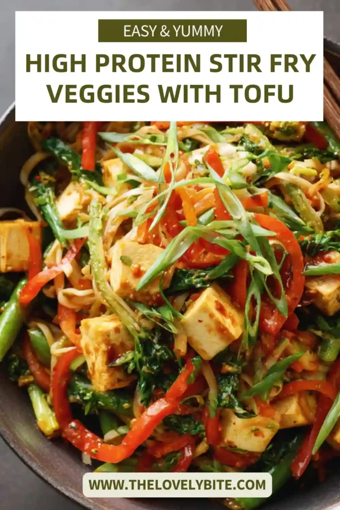 Close-up of a vegan tofu stir fry with ramen noodles, shredded carrots, and crisp vegetables in a glossy sesame sauce. This easy high protein dinner is perfect for weeknight meals.