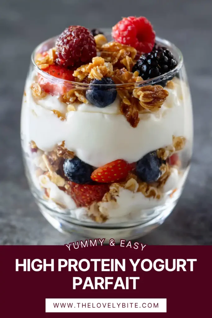 Close-up of a healthy High Protein Yogurt Parfait made with Greek yogurt, strawberries, blueberries, and crunchy granola. A quick and easy high protein breakfast option.