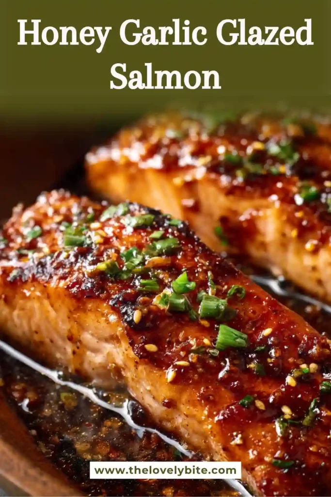 Broiled Honey Garlic Glazed Salmon filets in a cast iron skillet with sticky sweet savory glaze and fresh parsley. The salmon has crispy edges and a caramelized finish.