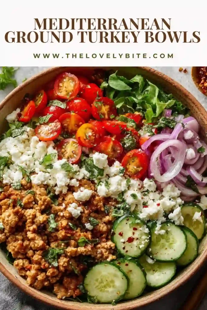 Close-up of Mediterranean Ground Turkey Bowls topped with cucumbers, tomatoes, olives, parsley, and lemon dressing. A healthy Mediterranean meal prep recipe packed with flavor.