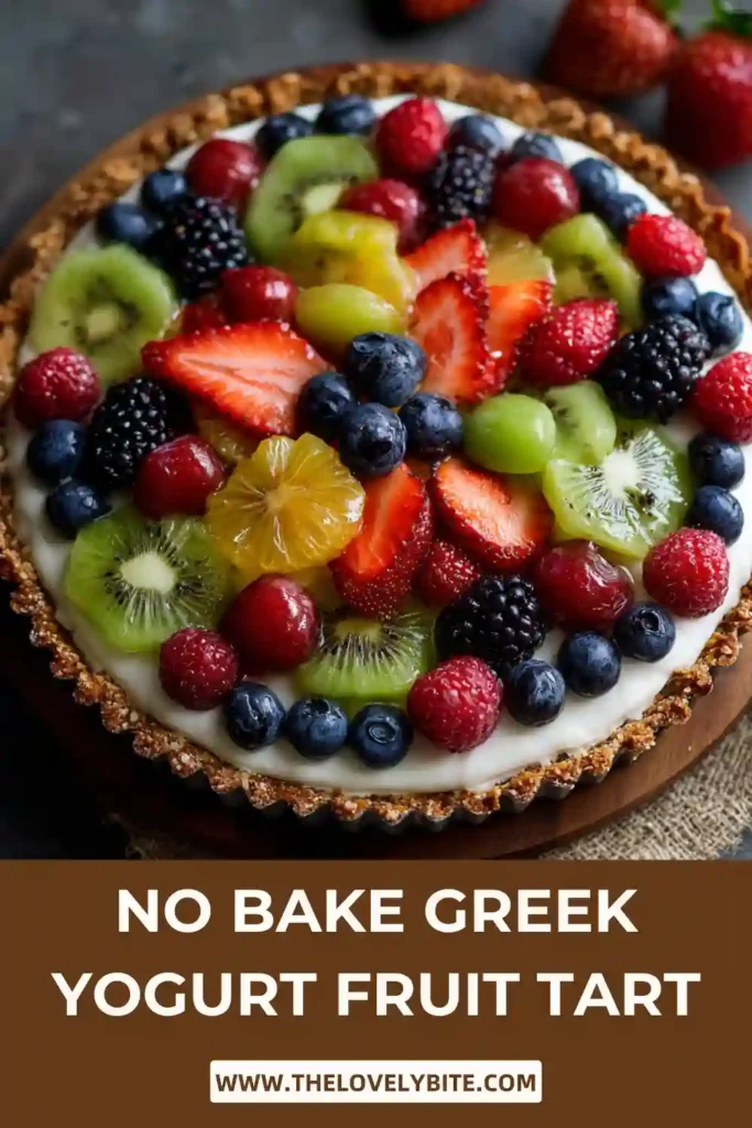 Overhead view of No Bake Greek Yogurt Fruit Tart decorated with fresh fruit and glossy finish on a natural crust base.
