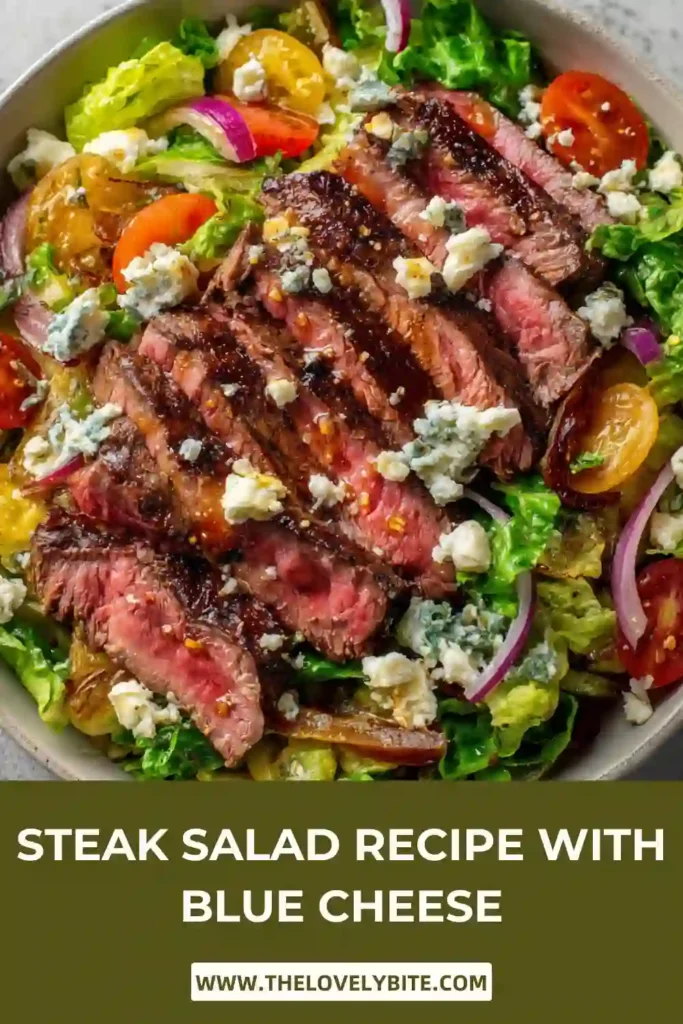 Fresh steak salad topped with blue cheese crumbles and olives in a rustic serving bowl. The vibrant vegetables and perfectly cooked steak create an inviting presentation.