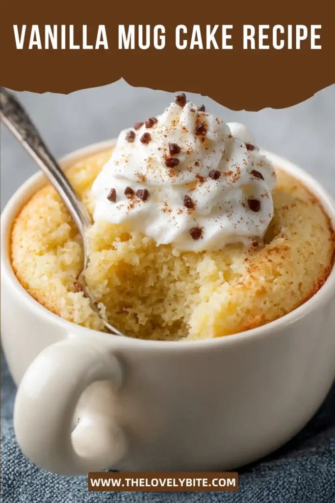 A healthy Vanilla Mug Cake topped with chocolate chips and served in a ceramic mug. The single-serve dessert looks soft, moist, and perfectly baked.