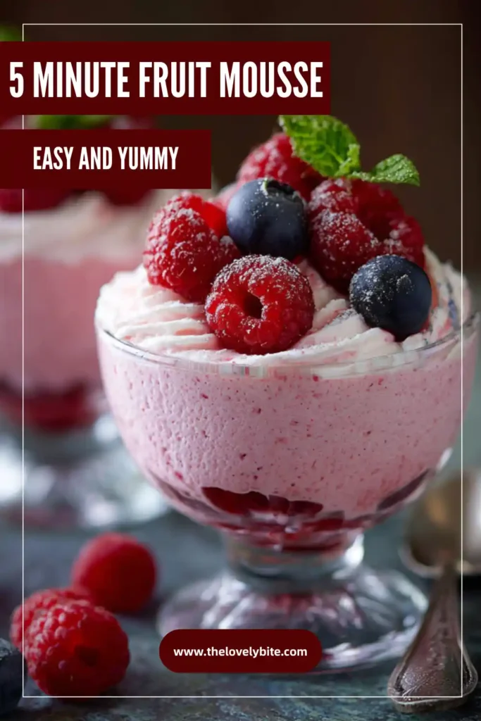 Creamy berry fruit mousse served in a dessert glass with whipped cream and fresh fruit. The mousse has a smooth texture and bright natural color.