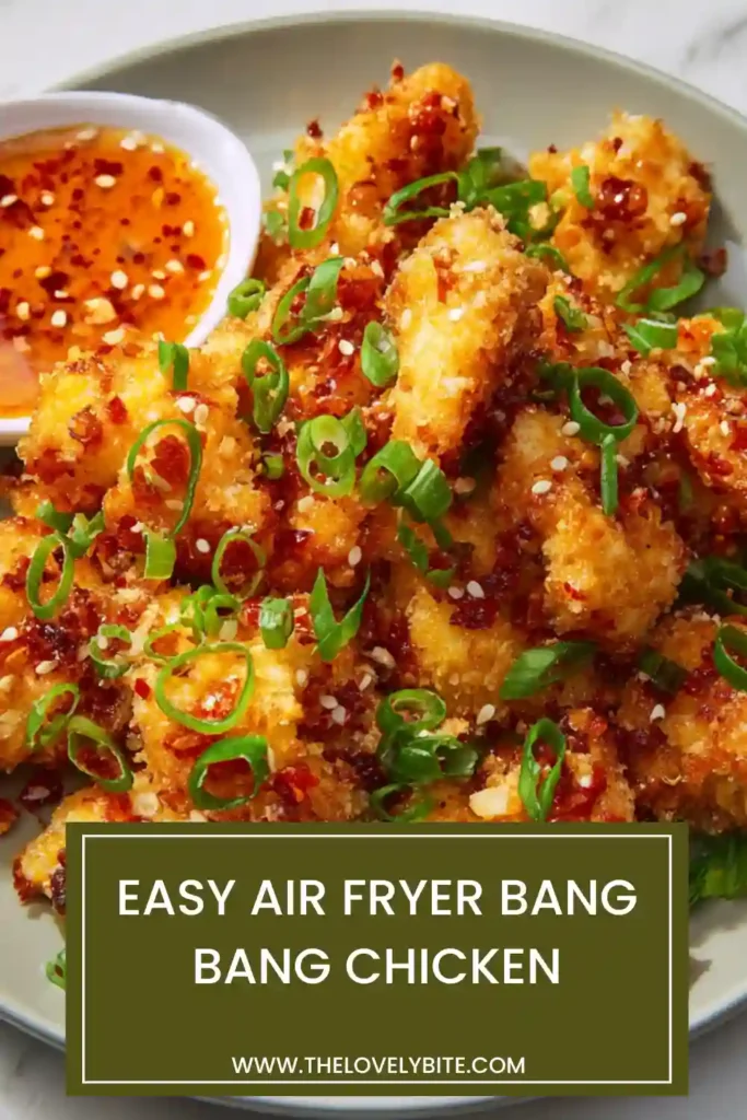 Close-up view of crispy Air Fryer Bang Bang Chicken served warm with creamy spicy sauce and chopped green onions. Perfect as an appetizer or main dish.