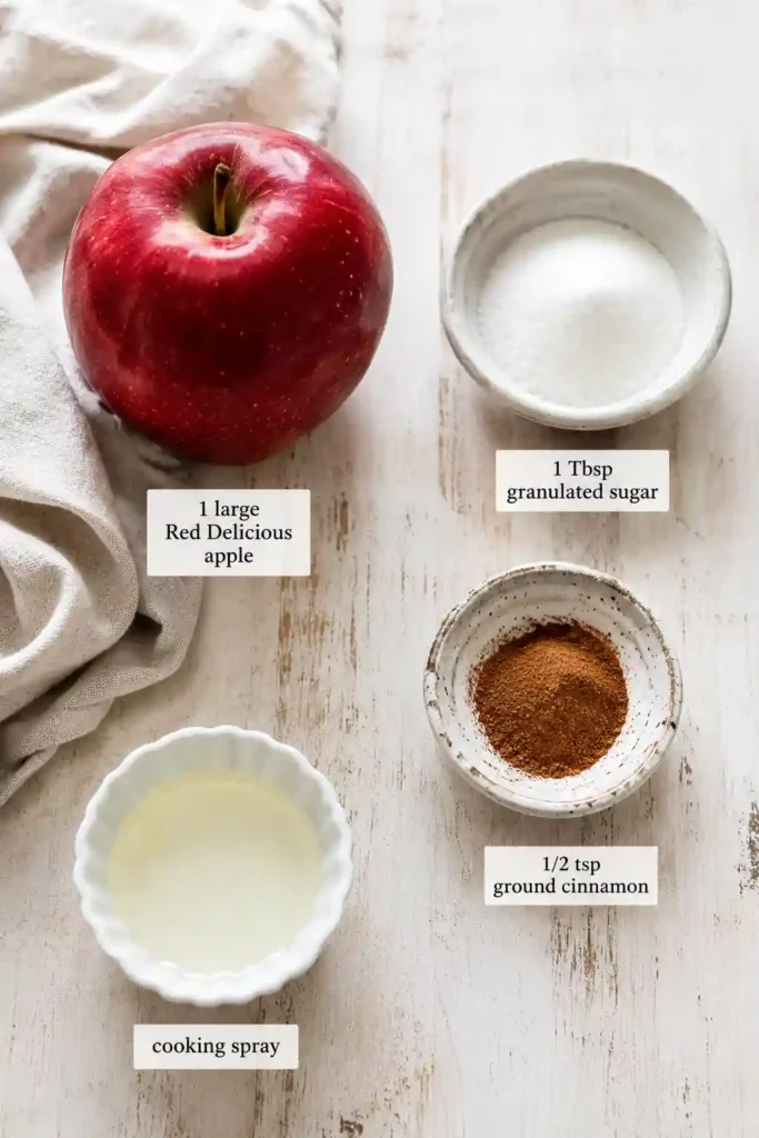 Fresh Air Fryer Cinnamon Apple Chips are arranged on a cooling rack with a light coating of cinnamon sugar. The homemade apple chips look crisp, golden, and perfect for a healthy snack.
